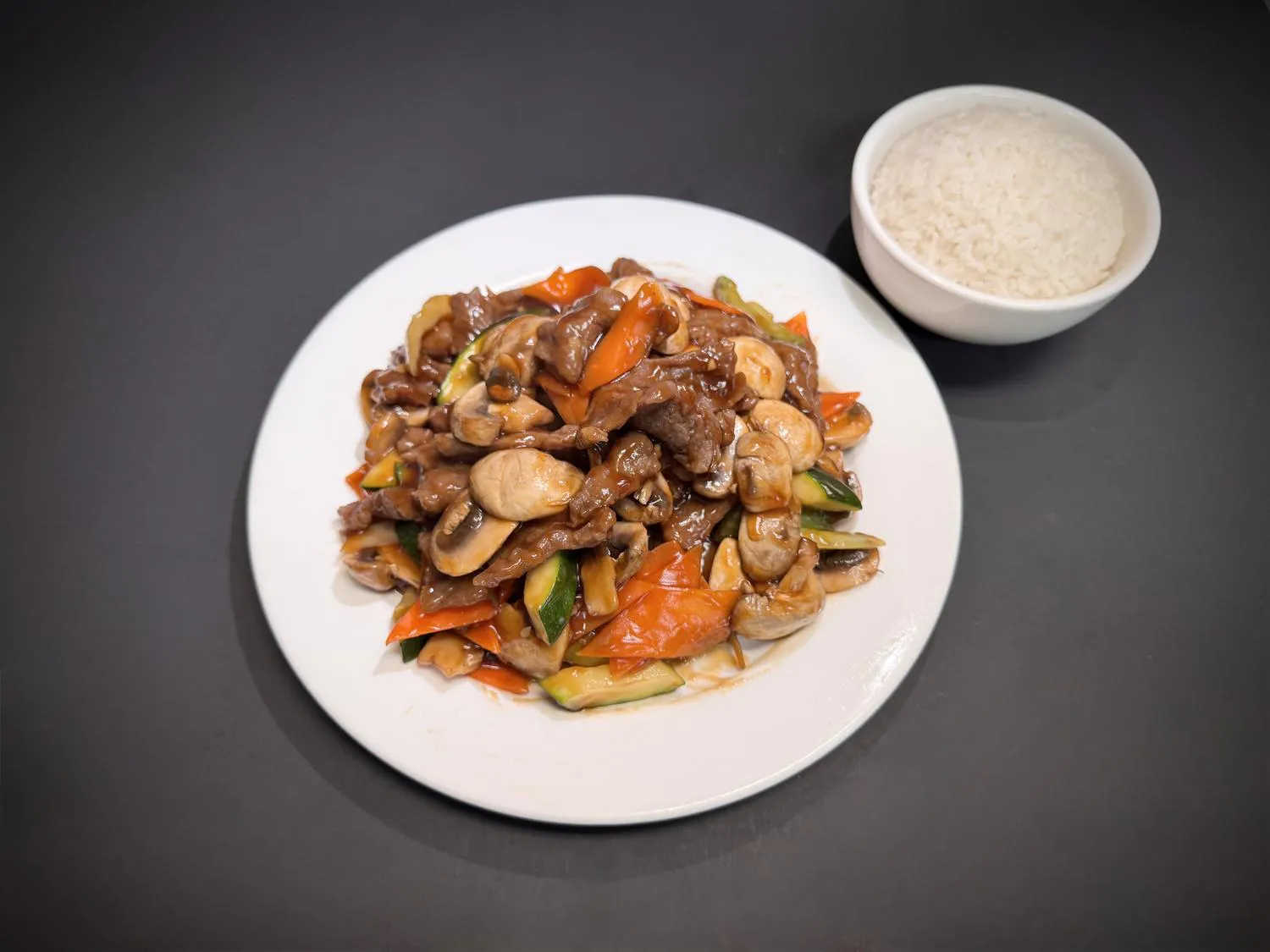 Beef mushroom stir‑fry with zucchini, carrots and steamed white rice at Lucky House, a Chinese restaurant in Surprise Beef mushroom stir‑fry with zucchini, carrots and steamed white rice at Lucky House, a Chinese restaurant in Surprise