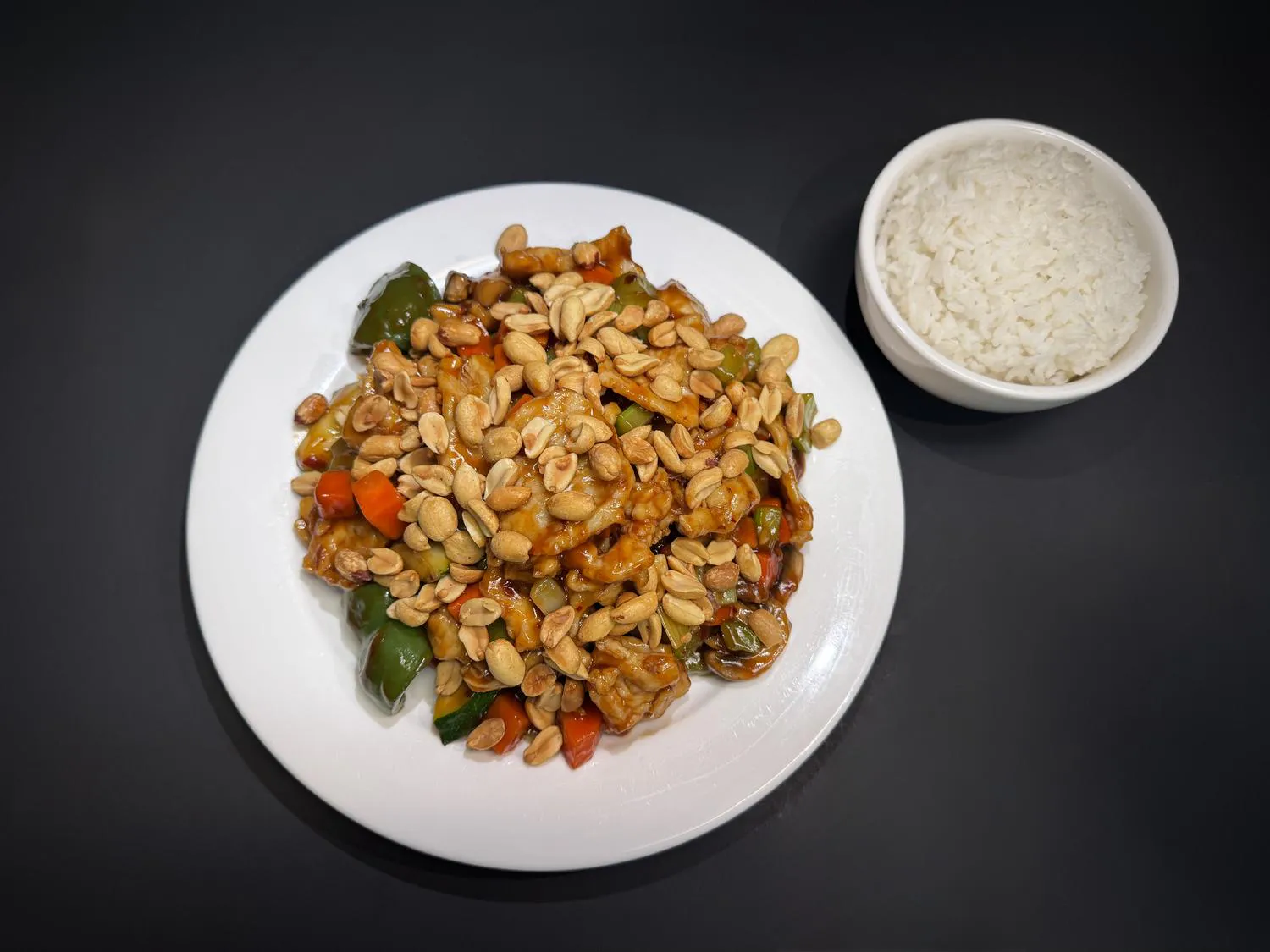 Kung pao chicken tossed with peanuts, bell peppers and diced vegetables with rice at Lucky House, a Chinese restaurant in Surprise Kung pao chicken tossed with peanuts, bell peppers and diced vegetables with rice at Lucky House, a Chinese restaurant in Surprise